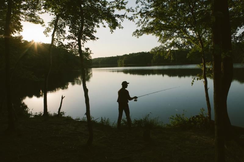 man fishing at sunrise