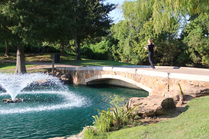 Oyster Creek Park bridge and woman running