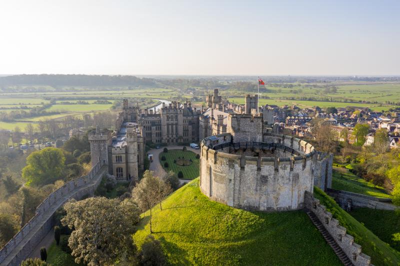 Aerial view of the keep at Arundel Castle with Arundel and fields in the distance