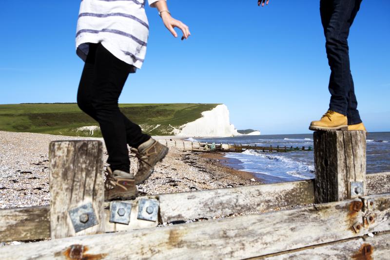A couple of walkers on the beach at Birling Gap near Seven sisters in the South Downs National Park