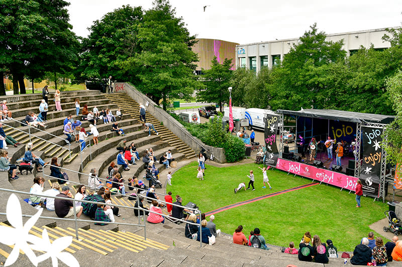 People sitting inside Swansea Amphitheatre