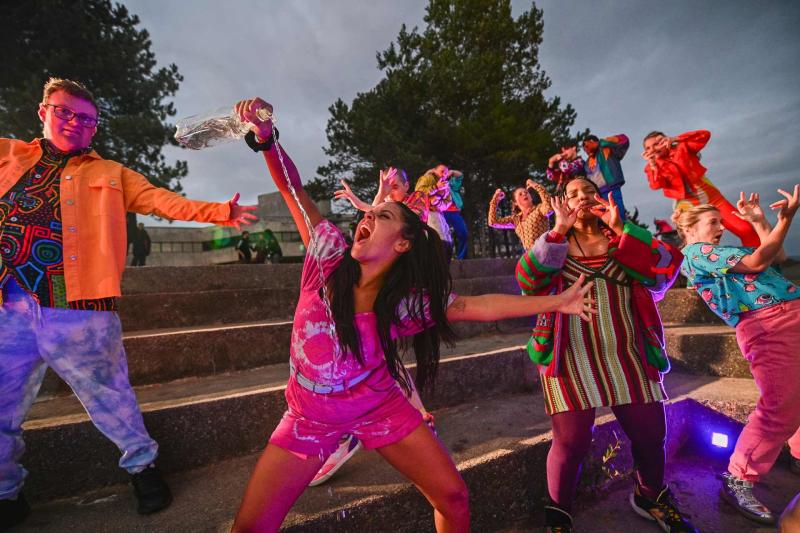 Dancers in colourful clothing dancing on Swansea prom