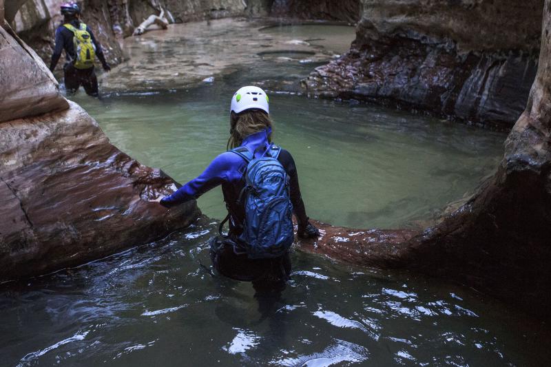 Woman Canyoneering in the Subway in Utah
