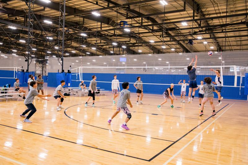 Two teams playing volleyball in the Sports Center
