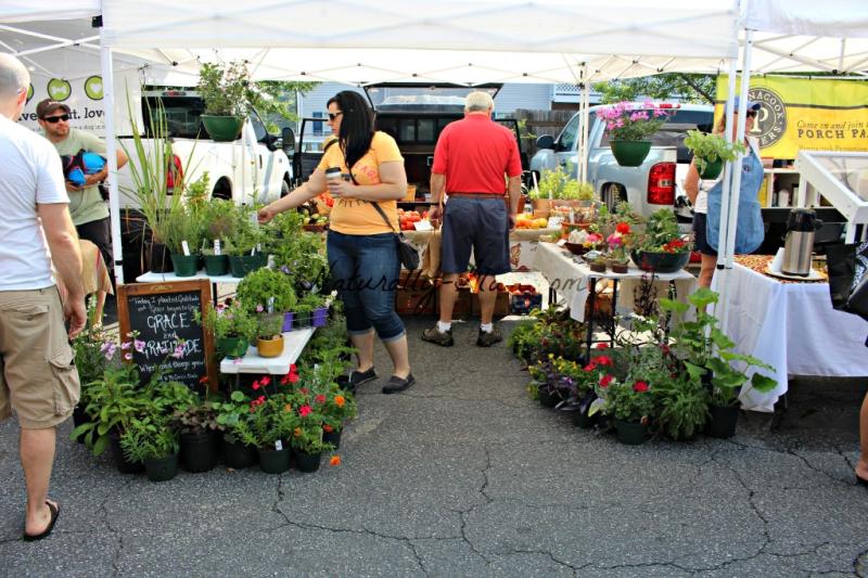 customers viewing offerings of produce at a farmer's market