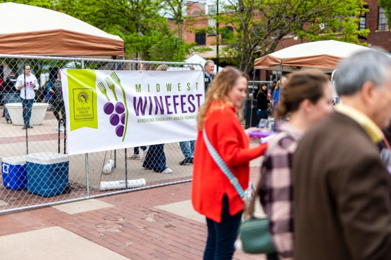 People sip wine outside in old town during Midwest Wine Fest