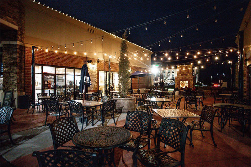 A nighttime photo of the outdoor patio at Oak & Pie