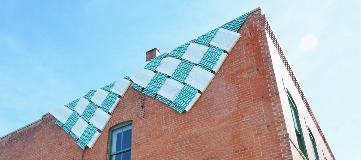 Checker art piece draped over the top of the BMoCA Helen and Alice