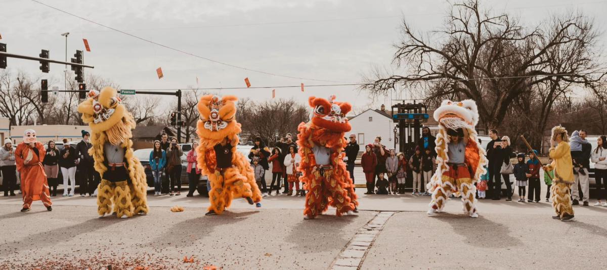 A dance team performs in dragon costumes as part of a Lunar New Year celebration