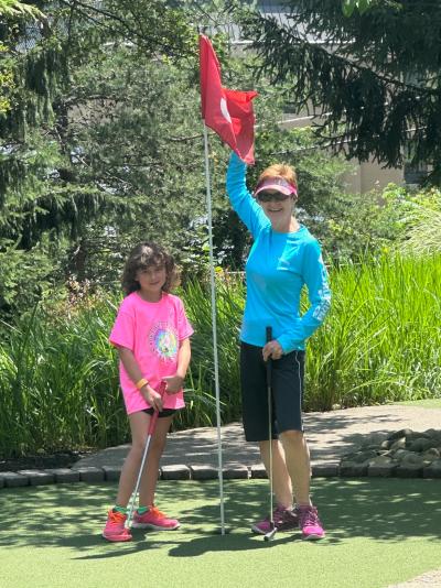 Two girls playing mini golf at Hooplas Xtreme Mini Golf