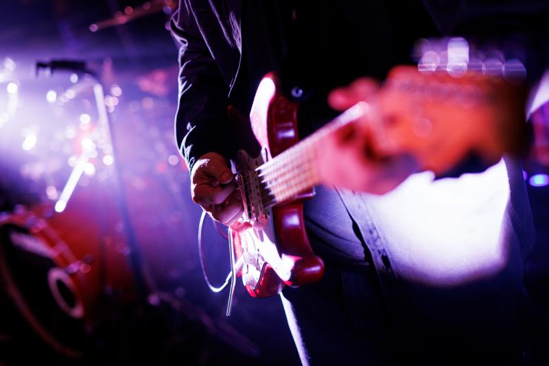 Someone plays the guitar during a performance.