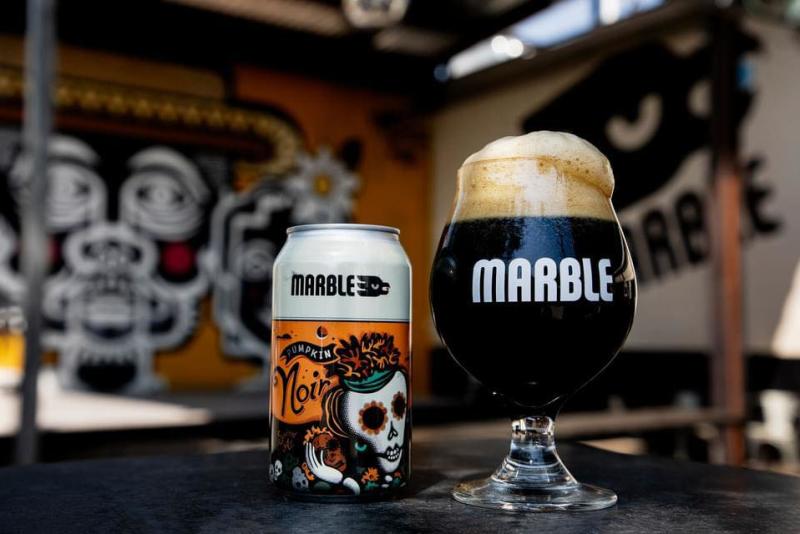 A can and glass of Pumpkin Noir beer from Marble Brewery