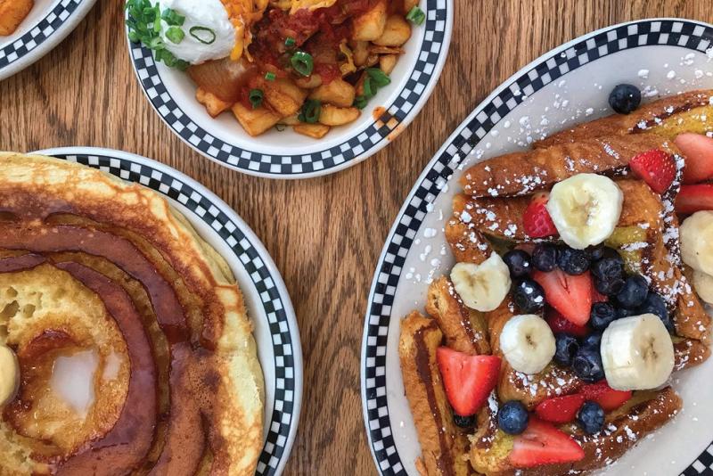 Three breakfast dishes on a table at The Village Deli