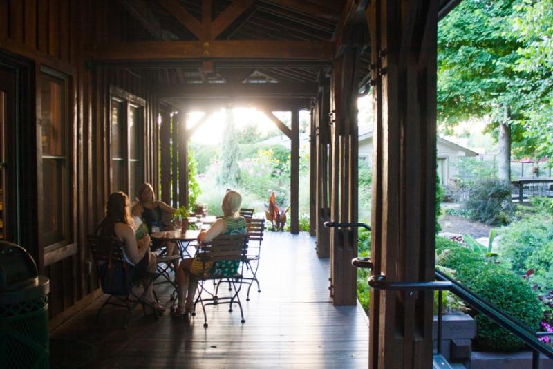 Three women sitting at a table on Oliver Winery's patio