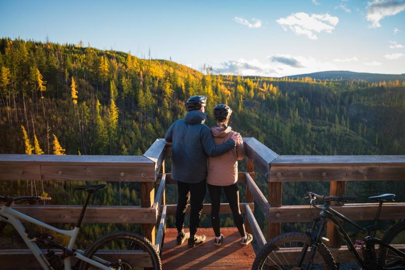 Couple taking in the view at Myra Canyon Trestles during Golden Larch Season 1