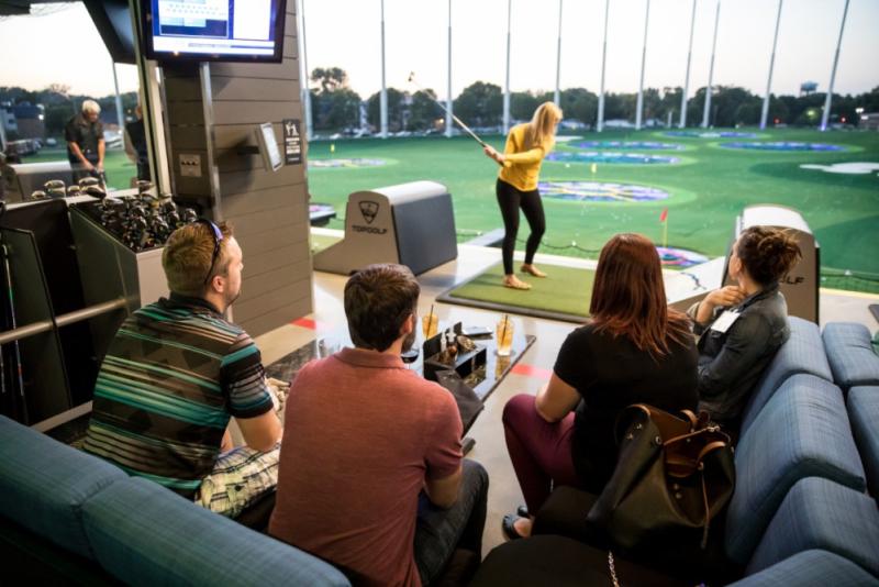 Person swinging a club at Topgolf