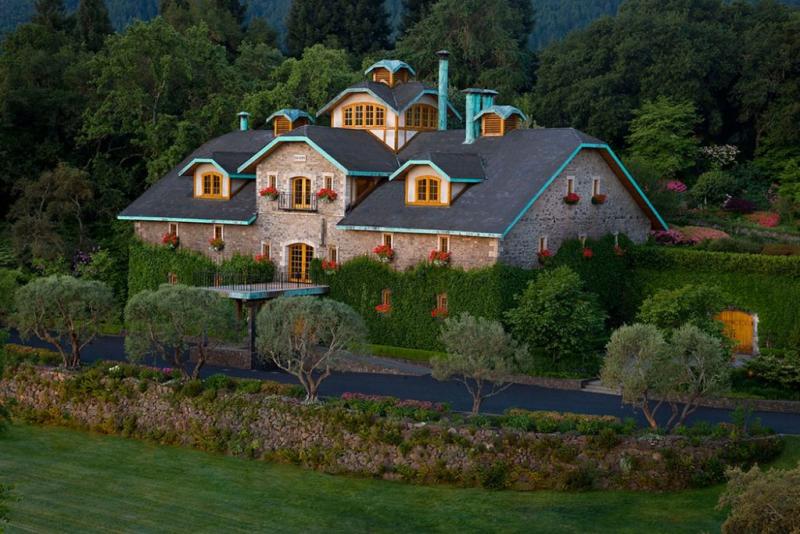 Located in Napa Valley's Oakville, Far Niente is a stone building with wood-frame windows and bright trim.