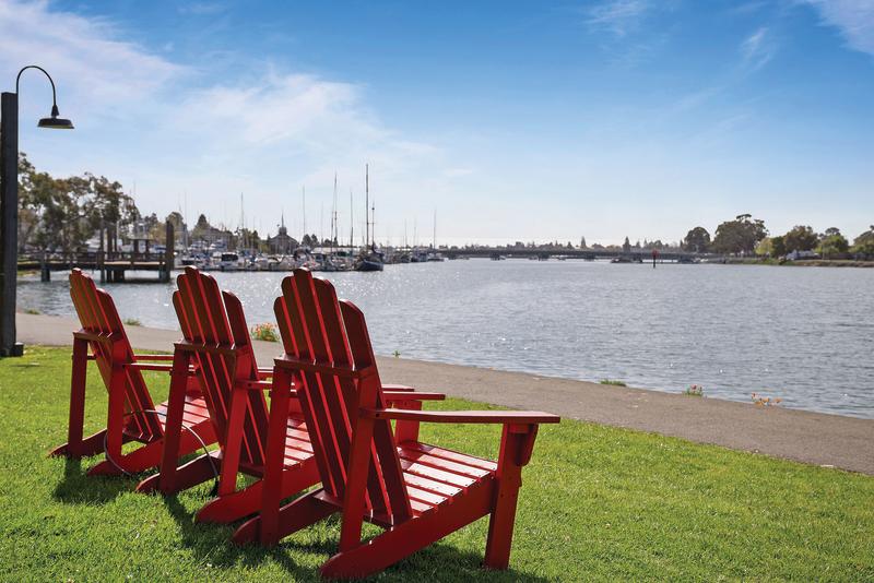 Lawn chairs overlooking the estuary at Executive Inn hotel in Oakland California