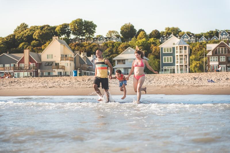 Family running into water