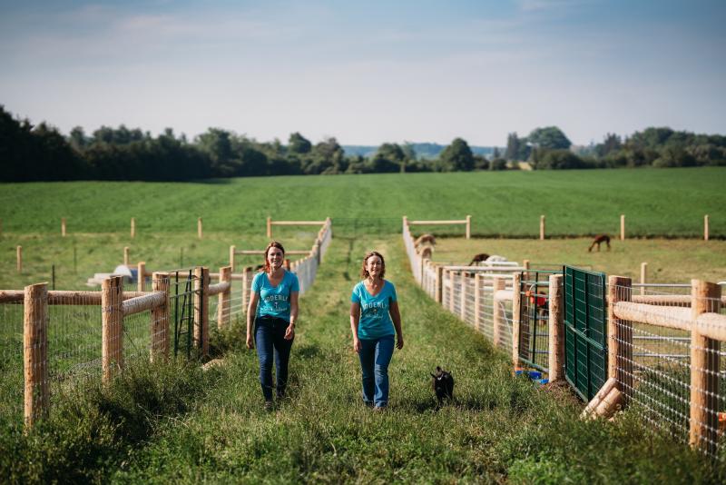 Women walking with goat