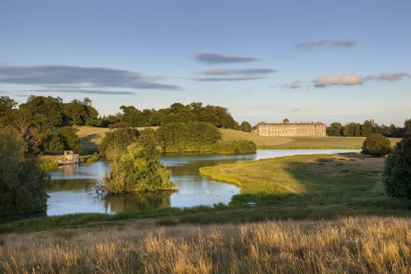 A view across the lake and deer park towards Petworth House in Sussex