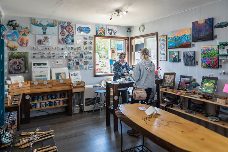 a woman purchases an item in an art shop