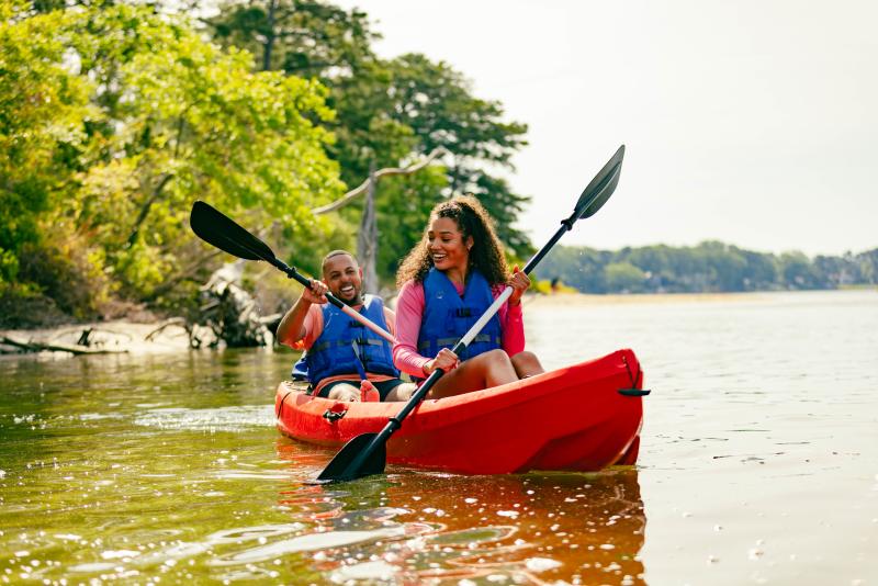 two people in kayak in shallow water