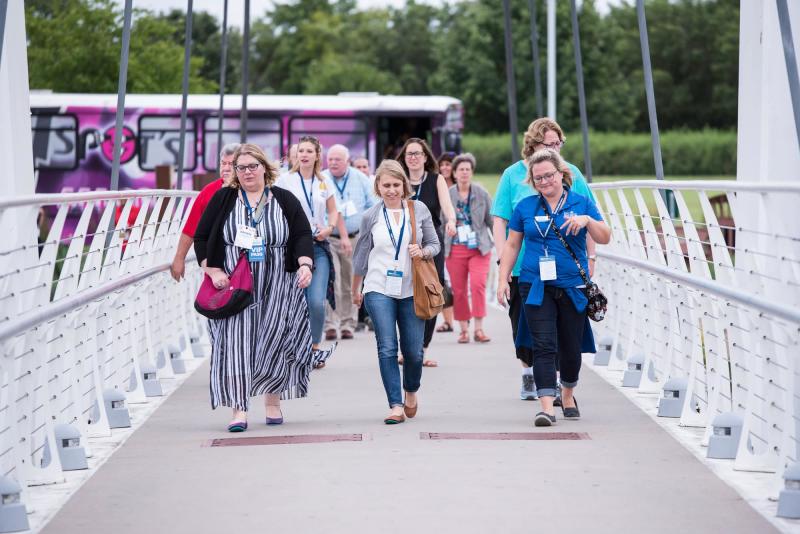 Group Visitors Crossing the Bridge to the Keeper of the Plains