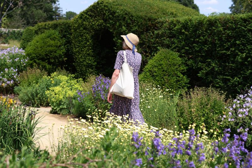 a person walking in formal gardens