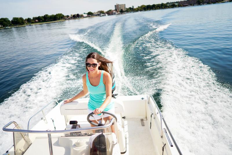 Woman driving a boat on Geneva Lake