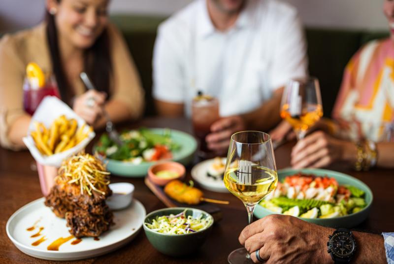 People eat a meal and drink wine at Mission Winery.