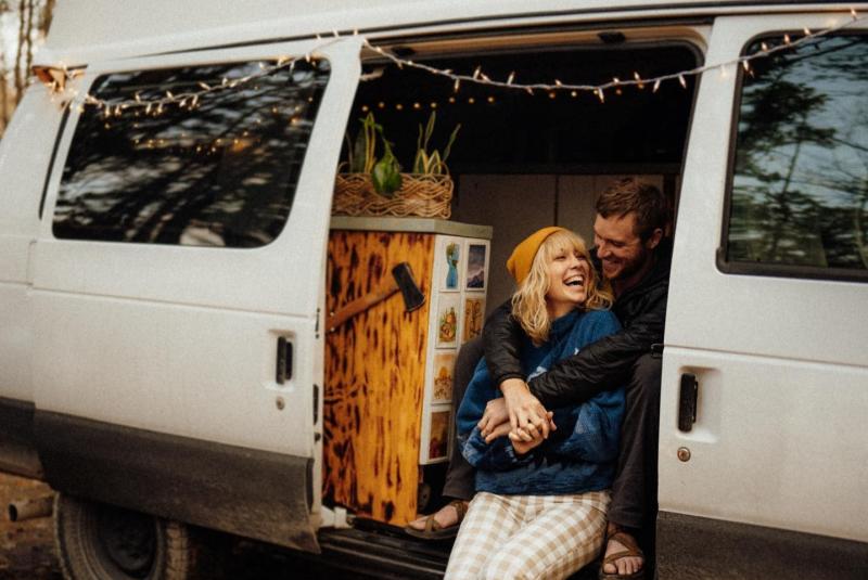 A couple embracing in the doorway of a camper van in the Hoosier National Forest