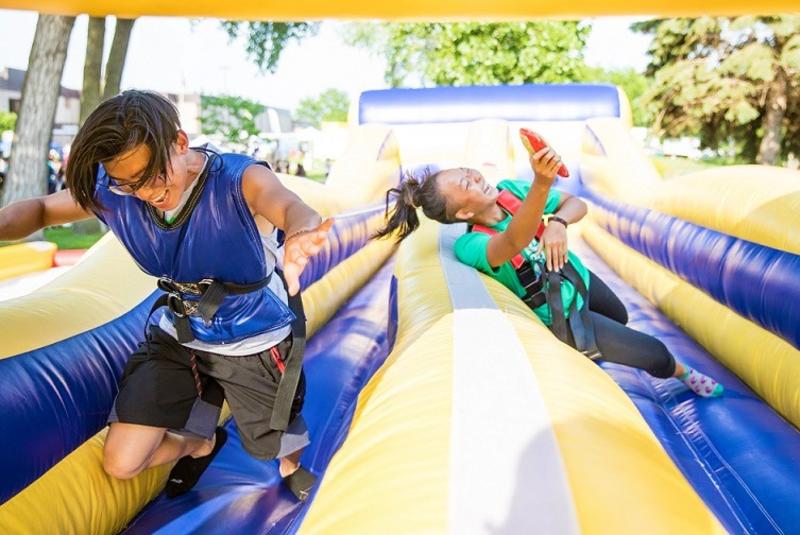 Teens playing on inflatables at Tater Daze festival