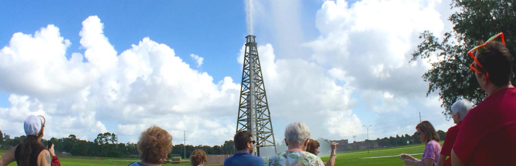 Spectators watch as the Spindletop Lucas gusher blows