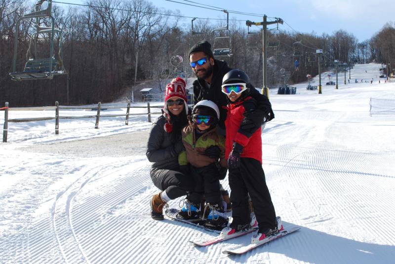 Family of four skiing at Spring Mountain