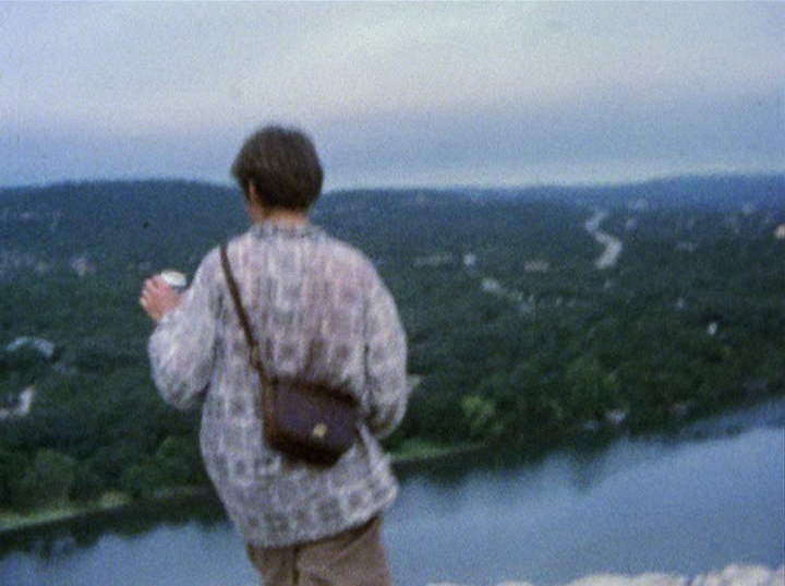 Slacker screengrab, showing the final scene with a person standing over Lake Austin at Mount Bonnell