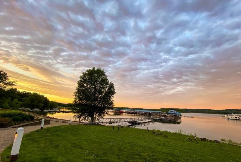 A view of Monroe Lake at sunset from the Fourwinds Lakeside Inn & Marina grounds