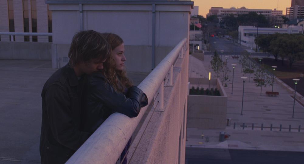 Boyhood screengrab, of Mason and Sheena standing on the roof of an Austin Parking Garage