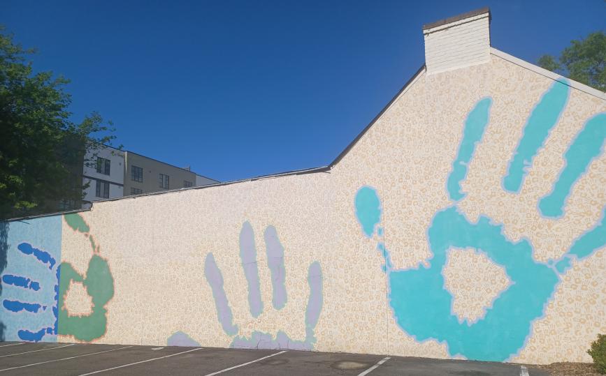 Outdoor Building Mural Called 'Hands" by Michael Brown