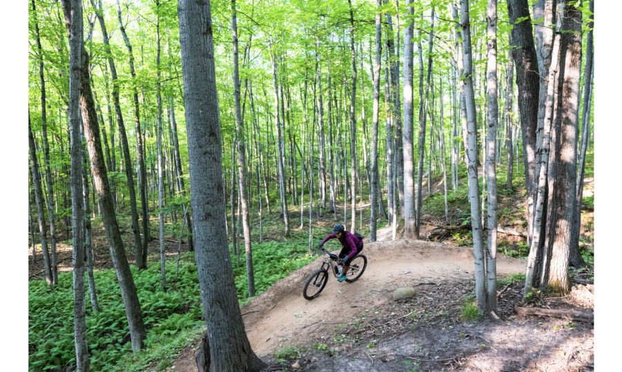 Woman mountain biking on NTN South Trails in Marquette, MI