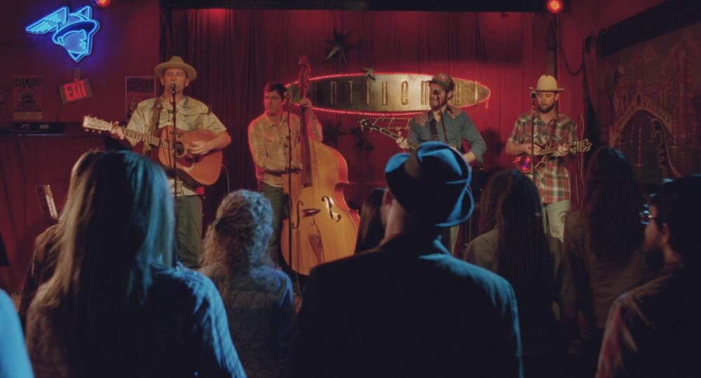 Boyhood screengrab showing a band on stage at the Continental Club in front of a red velvet curtain