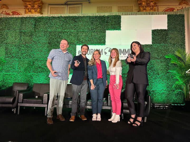 The five winners of the eTourism Summit Emerging Tourism stars hold their awards on stage, including Visit Albuquerque's social media specialist Lara Brockway