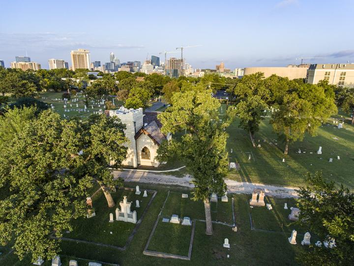 Aerial shot of Oakwood Cemetery with downtown skyline in the background