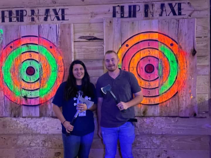 man and woman at an axe-throwing place