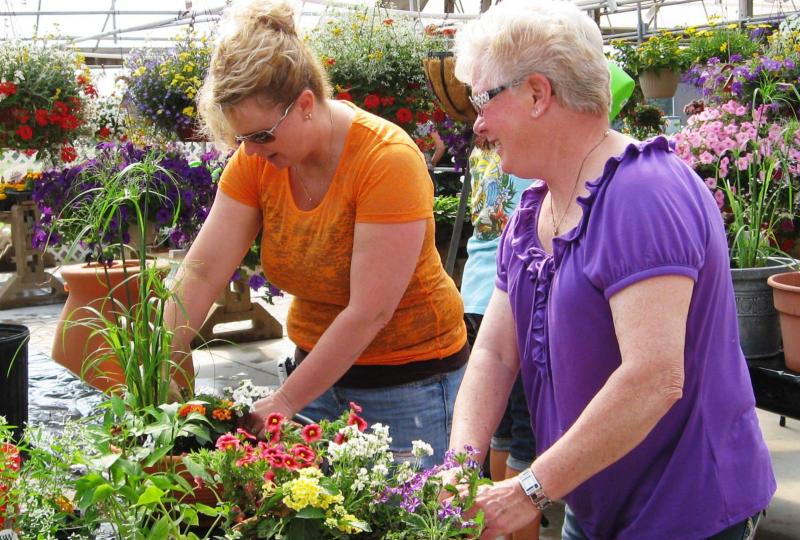 Participants at the Wines & Vines Container Gardening Party at Greendell Landscaping Solutions in Mooresville create their own beautiful potted creations!