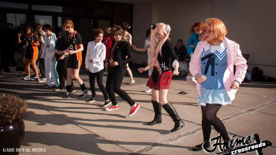 Attendees forming a dance line at Anime Crossroads.