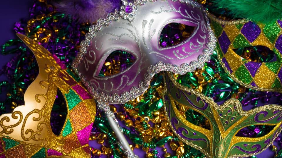 Image is of 4 different types of Mardi Gras masks in many different colors.