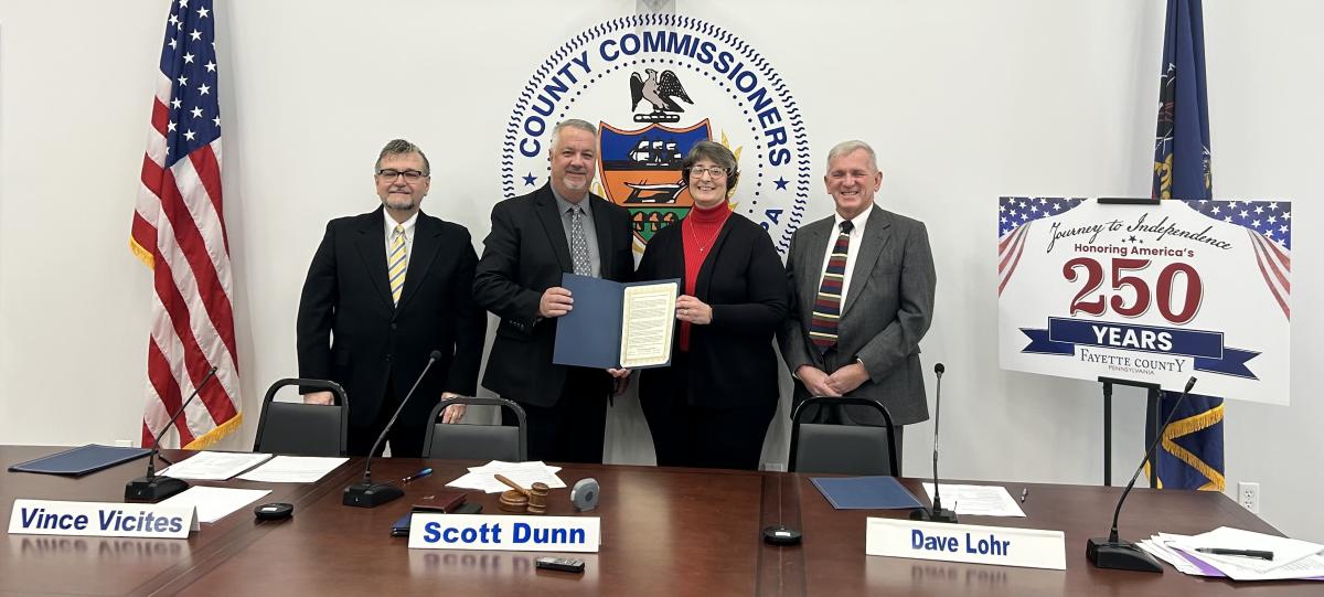 Fayette County Commissioners Vince Vicetes (left), Scott Dunn (center) and Dave Lohr are shown with Muriel Nuttall, executive director of the Fayette Chamber of Commerce.