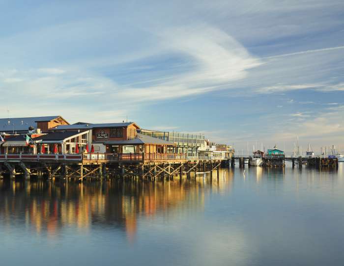 Wide shot of Old Fisherman's Wharf at Dusk Reflecting on the Monterey Bay