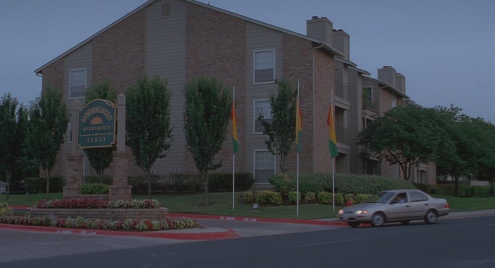 Office Space screengrab, showing the exterior and sign at Morningwood Apartments